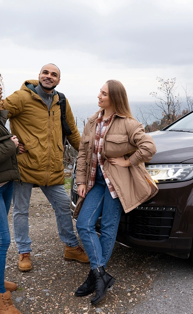 Travelers with an SUV on a scenic roadside